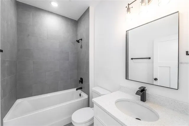 a bathroom with a sink a toilet and bathtub