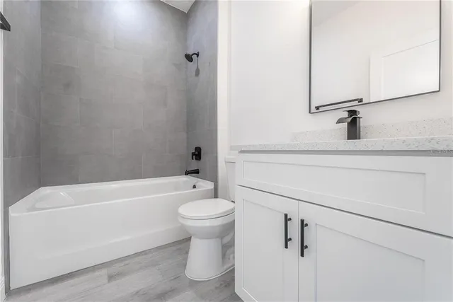 a white bath tub sitting next to a white toilet