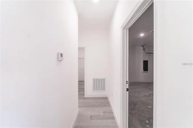 en empty room with projector and stainless steel appliances