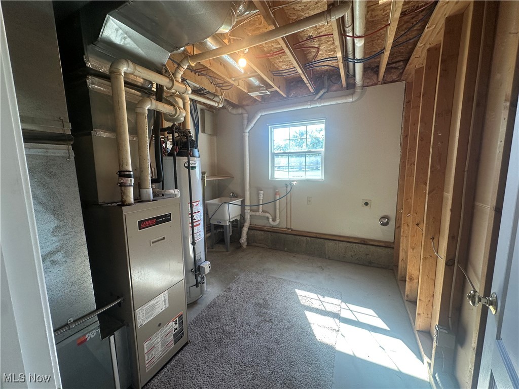 9137 Maple Grove Road Windham, OH 44288 - Photo 17 of 17 Utility room featuring gas water heater and heating unit