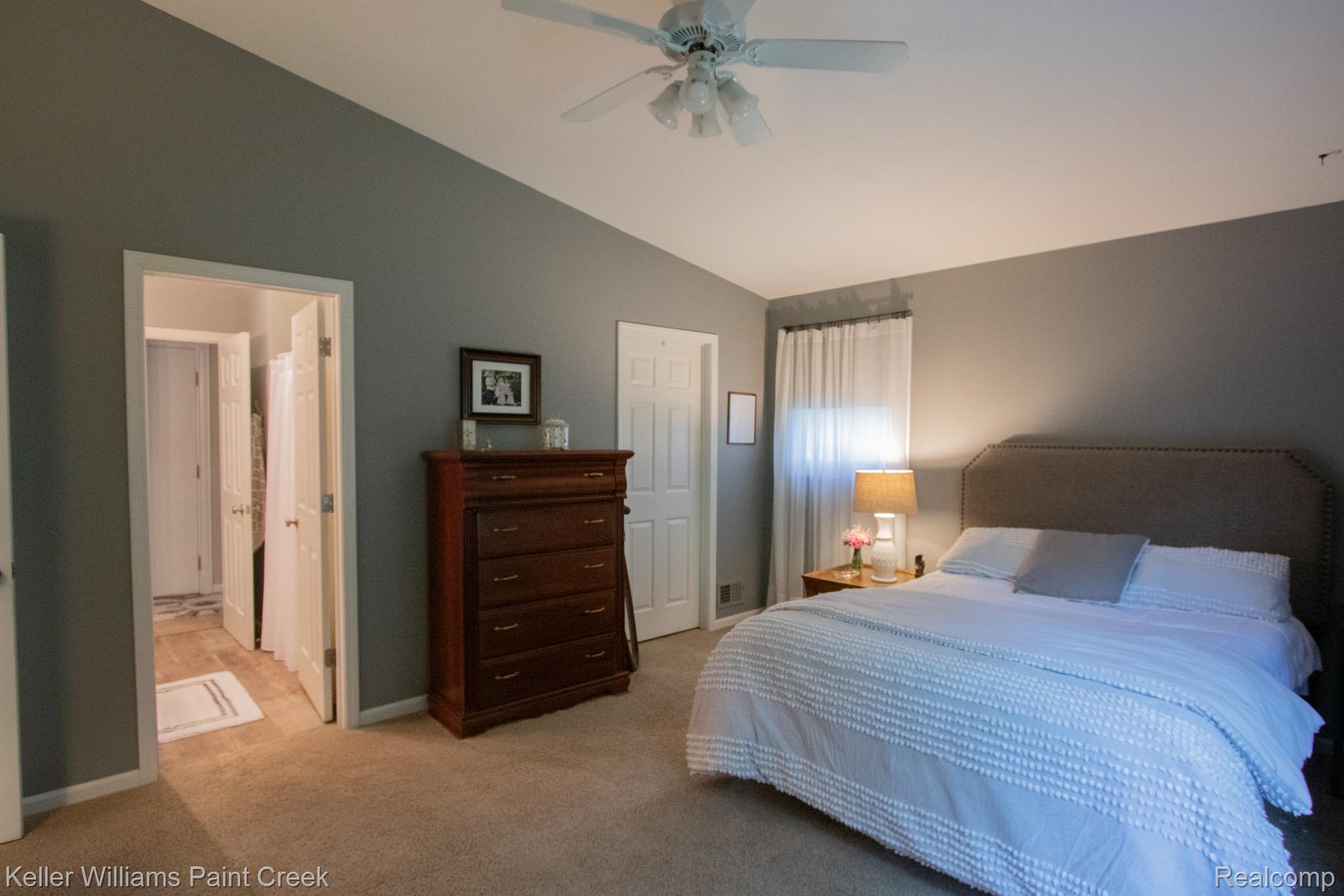 70696 Mellen Street Romeo, MI 48065 - Photo 18 of 46 Bedroom with vaulted ceiling, light colored carpet, and a ceiling fan