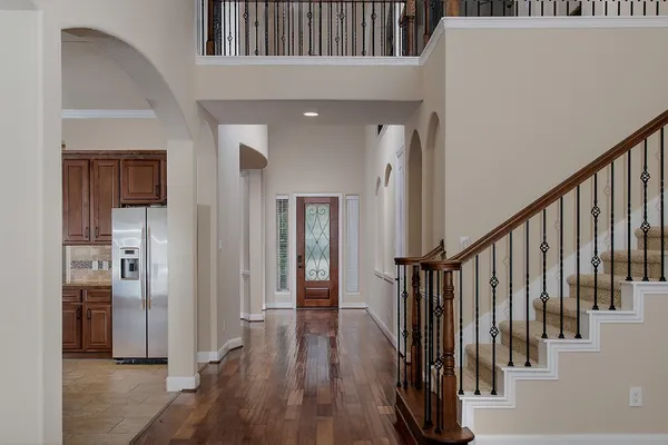 a view of an entryway with wooden floor and stairs