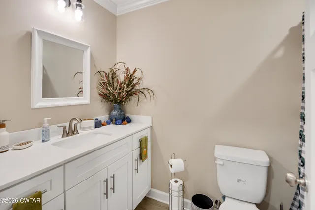 a bathroom with a sink a toilet and a mirror