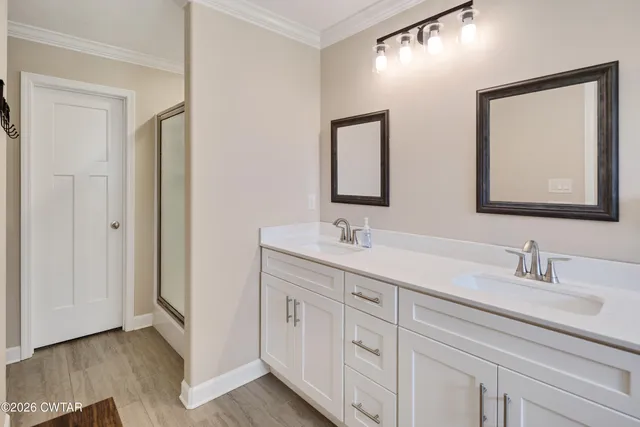 a bathroom with a double vanity sink and mirror