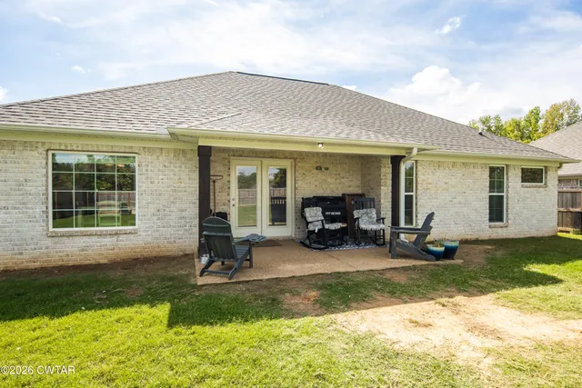a view of a house with backyard porch and sitting area