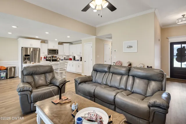 a living room with furniture and a chandelier