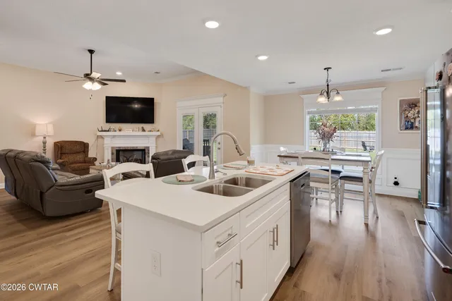 a living room with furniture a flat screen tv and a large window