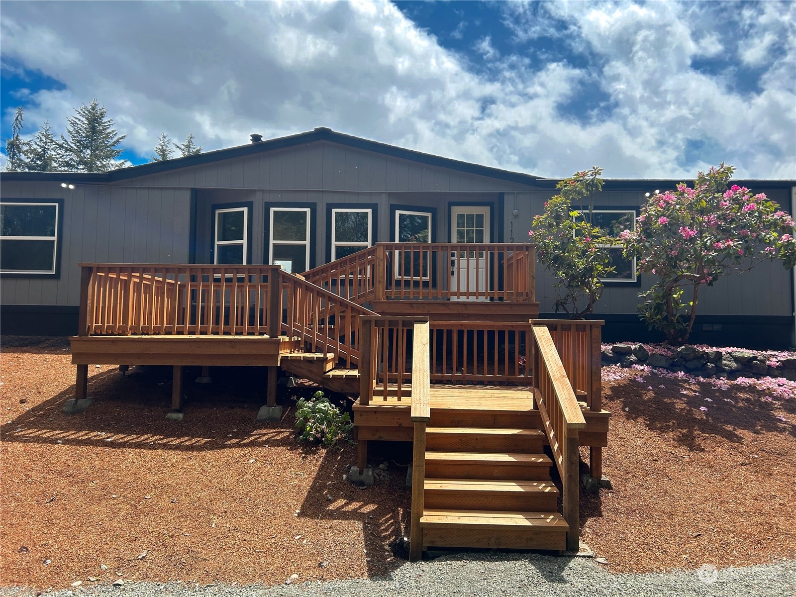 112 Levig Road Port Angeles, WA 98362 - Photo 1 of 37 a view of a house with wooden deck and furniture