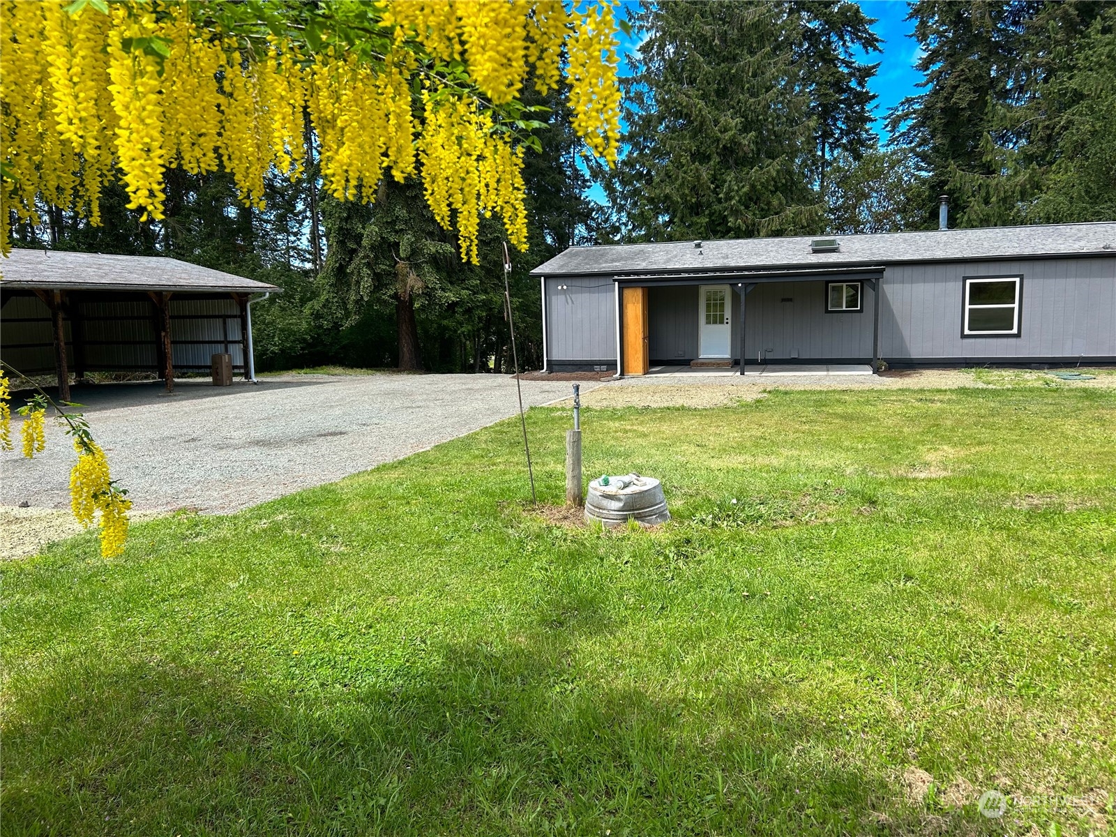 112 Levig Road Port Angeles, WA 98362 - Photo 35 of 37 a backyard of a house with table and chairs