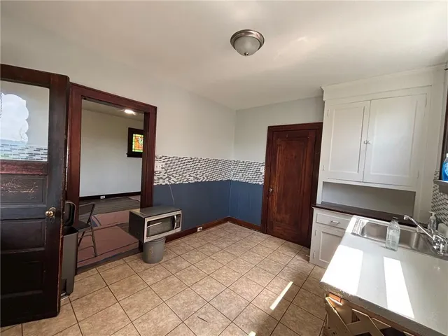 a kitchen with a sink a stove and cabinets