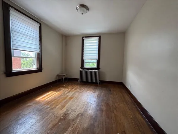 a bedroom with a bed a table and a window