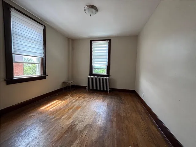 a bedroom with a bed a table and a window