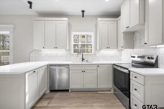 a kitchen with a sink stove and cabinets