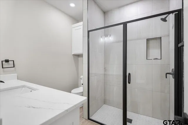 a bathroom with a shower and a sink