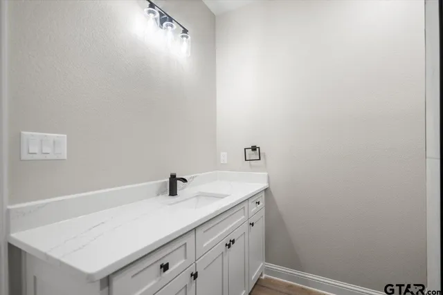 a bathroom with a sink and vanity