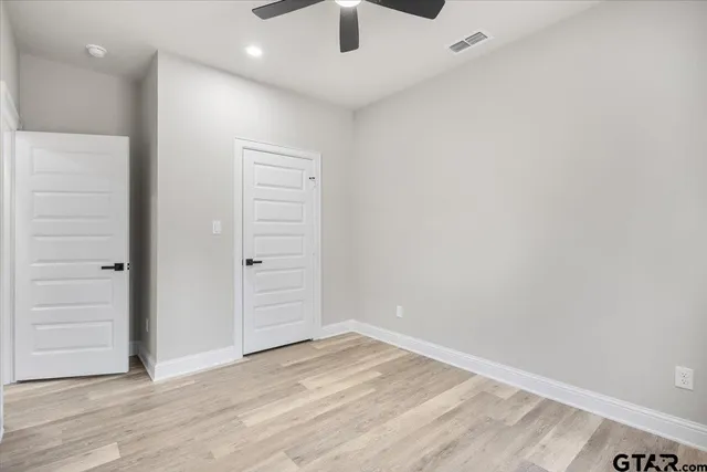 an empty room with wooden floor