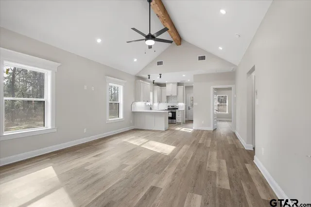 a view of a living room a kitchen and a wooden floor