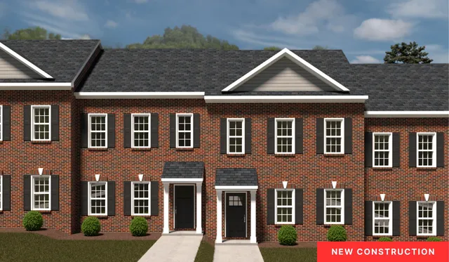 a front view of a residential apartment building with a yard