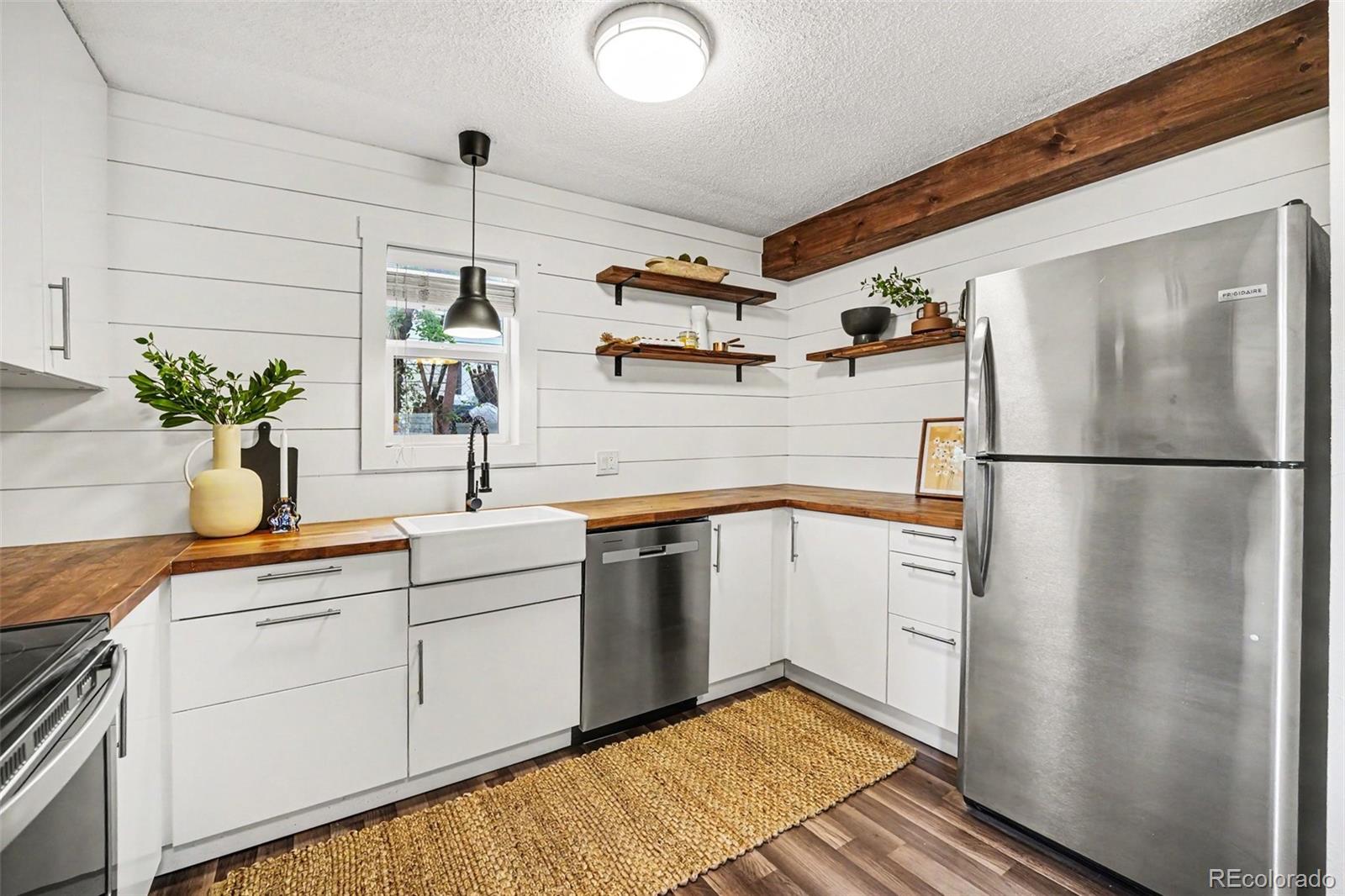5700 West 28th Avenue, Unit 1 Wheat Ridge, CO 80214 - Photo 16 of 25 a kitchen with appliances cabinets and a sink