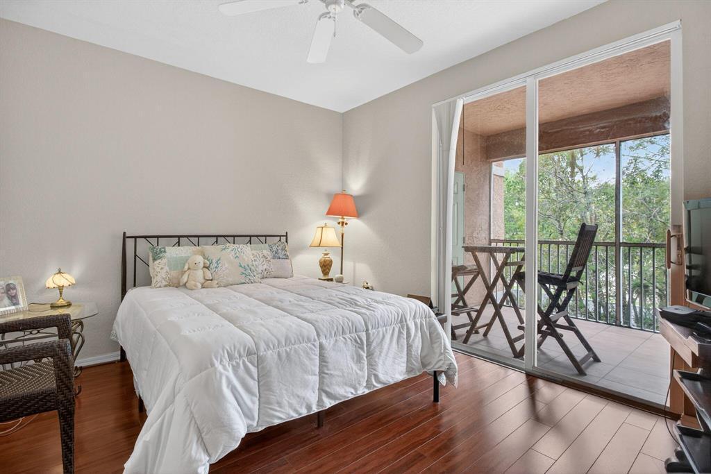 6890 West Sample Road, Unit 6890 Pompano Beach, FL 33063 - Photo 7 of 15 Master bedroom with patio