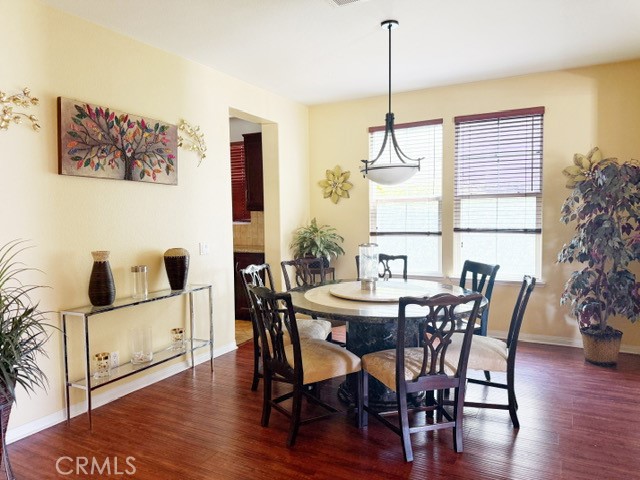 12647 Burbank Road Eastvale, CA 92880 - Photo 12 of 14 a view of a dining room with furniture window and wooden floor