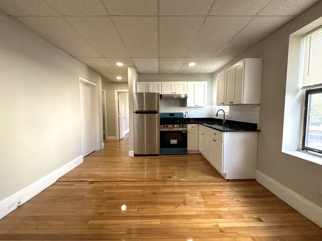 a kitchen with stainless steel appliances granite countertop a sink and a stove top oven