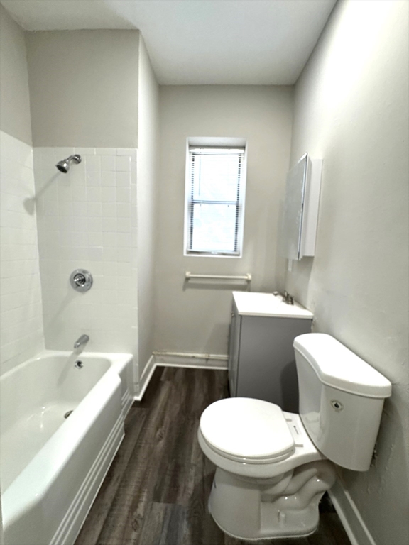 8 Langmaid Avenue, Unit 4 Somerville, MA 02145 - Photo 4 of 8 a bathroom with a toilet sink and bathtub