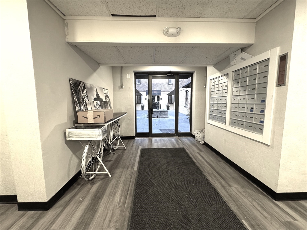 8 Langmaid Avenue, Unit 4 Somerville, MA 02145 - Photo 5 of 8 a view of a livingroom with wooden floor and furniture