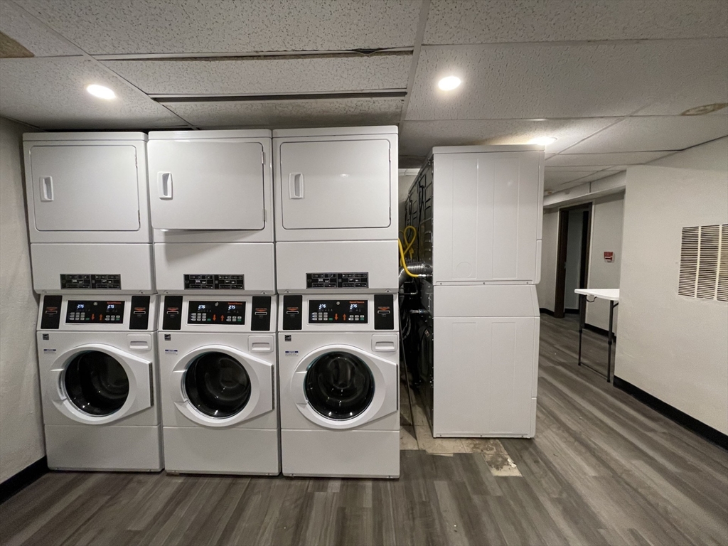 8 Langmaid Avenue, Unit 4 Somerville, MA 02145 - Photo 7 of 8 a utility room with dryer washer and a view of living room