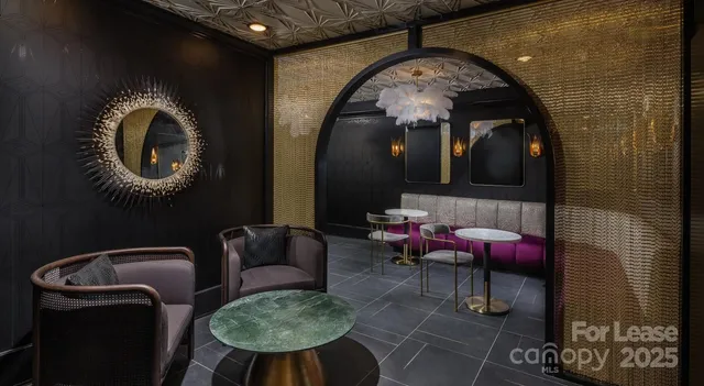 a living room with furniture and a mirror