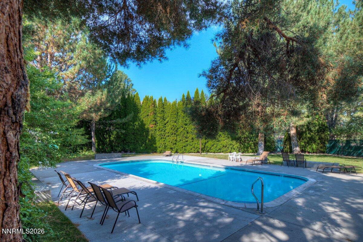 4380 Matich Drive Reno, NV 89502 - Photo 20 of 21 a view of a backyard with lawn chairs and a fire pit