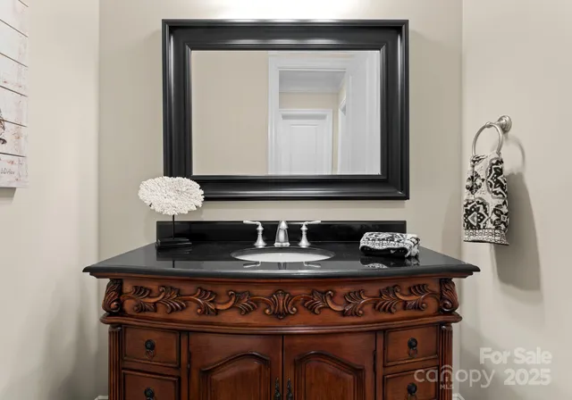 a spacious bathroom with a granite countertop sink mirror and bathtub