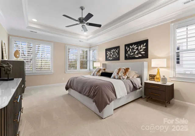 a bedroom with a bed and a chandelier