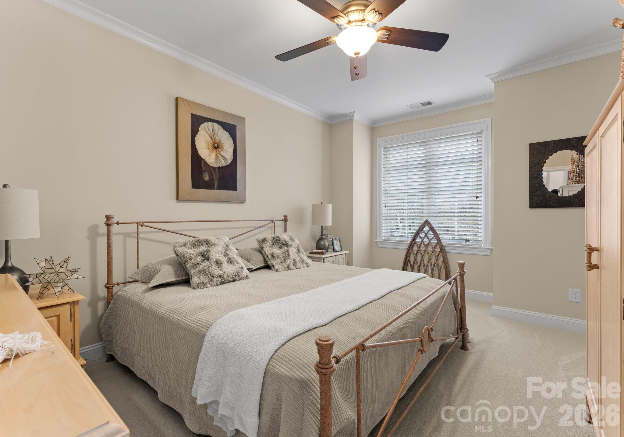 21311 Baltic Drive Cornelius, NC 28031 - Photo 24 of 39 a bedroom with a bed and a chandelier