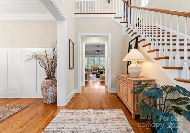 a view of entryway and hall with wooden floor