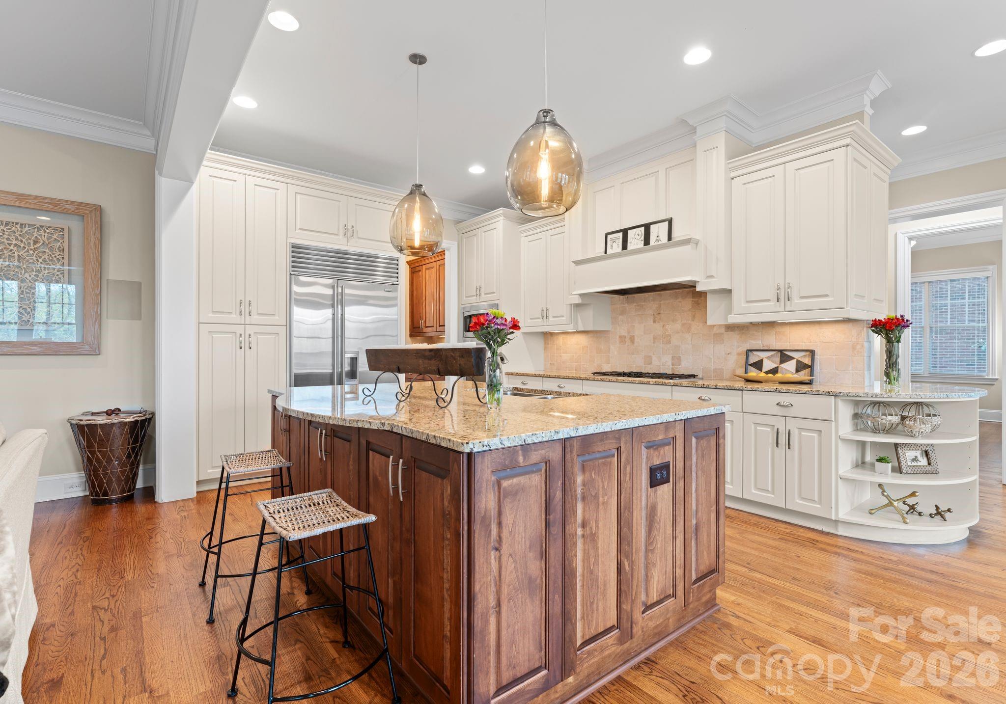 21311 Baltic Drive Cornelius, NC 28031 - Photo 9 of 39 a kitchen with stainless steel appliances granite countertop a stove a sink dishwasher and a refrigerator with wooden floor