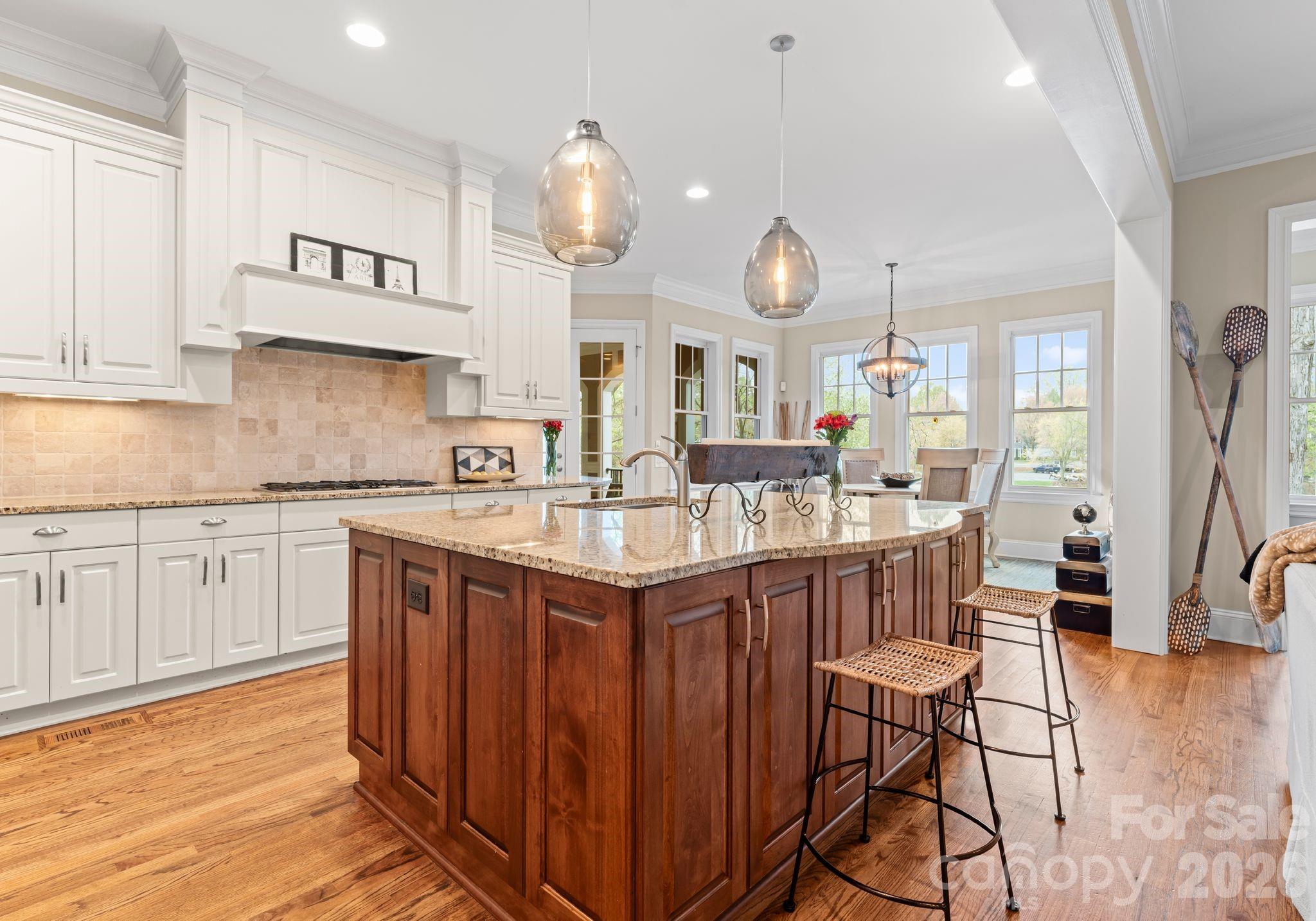 21311 Baltic Drive Cornelius, NC 28031 - Photo 10 of 39 a kitchen with granite countertop a sink cabinets and wooden floor