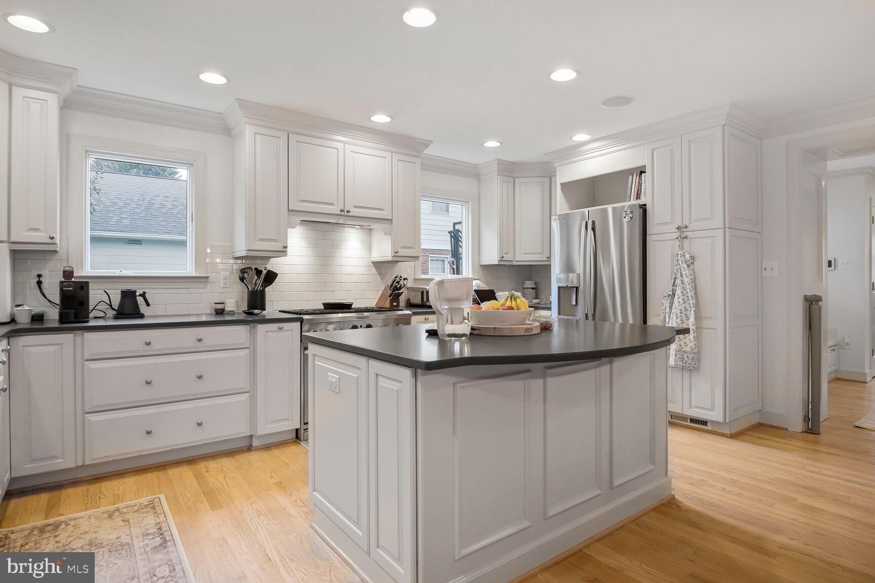 4403 Edgefield Road Kensington, MD 20895 - Photo 11 of 30 a kitchen with stainless steel appliances granite countertop a sink a stove a refrigerator and cabinets