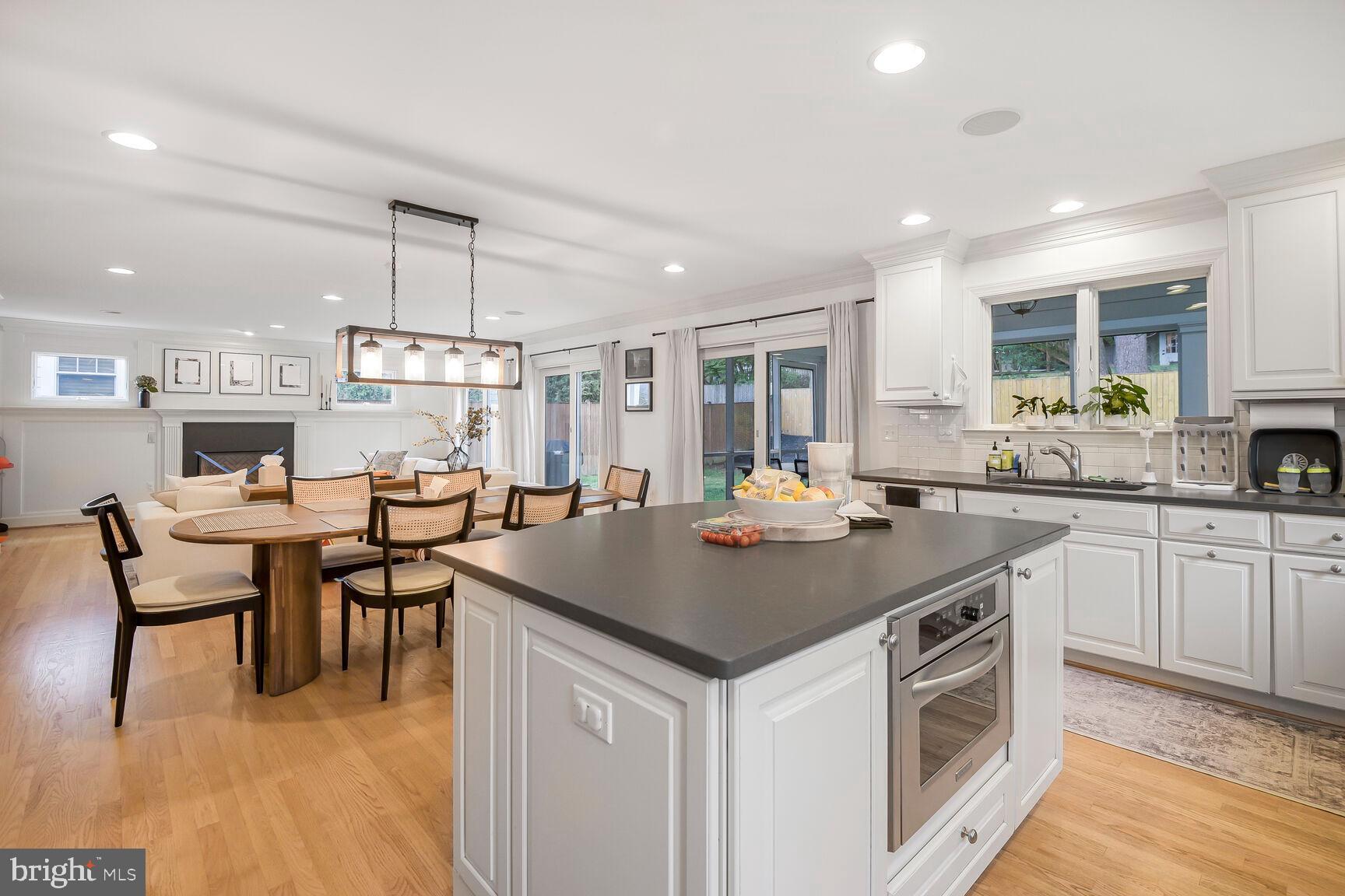 4403 Edgefield Road Kensington, MD 20895 - Photo 12 of 30 a kitchen with a table chairs stove and microwave