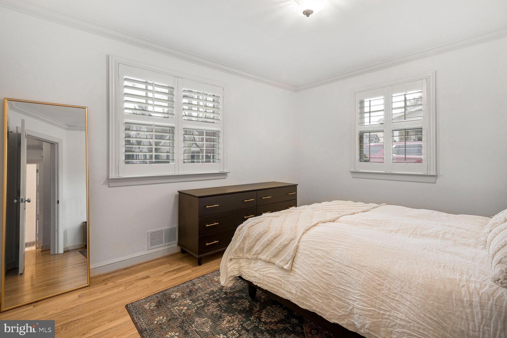 4403 Edgefield Road Kensington, MD 20895 - Photo 18 of 30 a bedroom with a bed and wooden floor