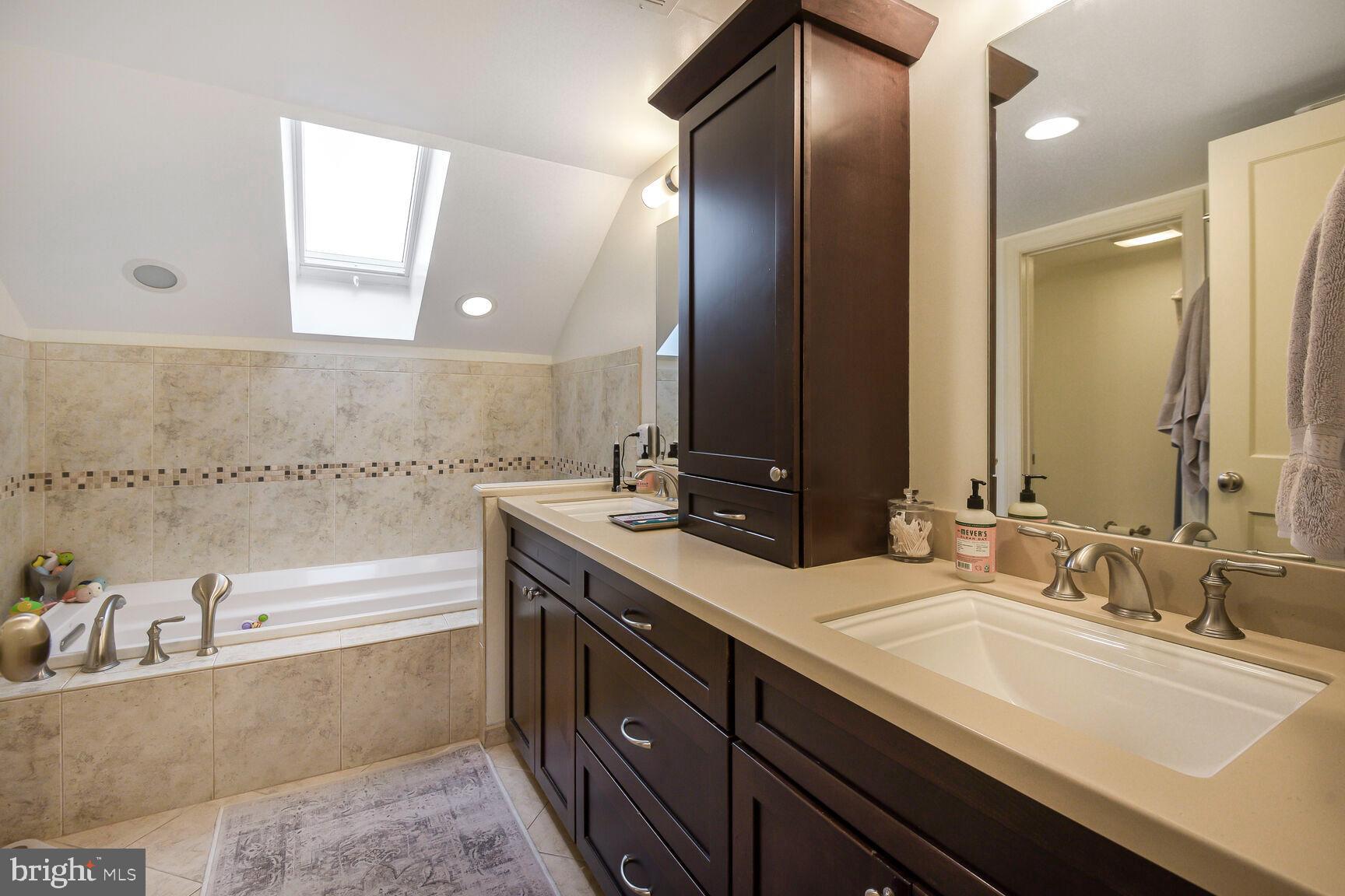 4403 Edgefield Road Kensington, MD 20895 - Photo 25 of 30 a bathroom with a tub sink and mirror