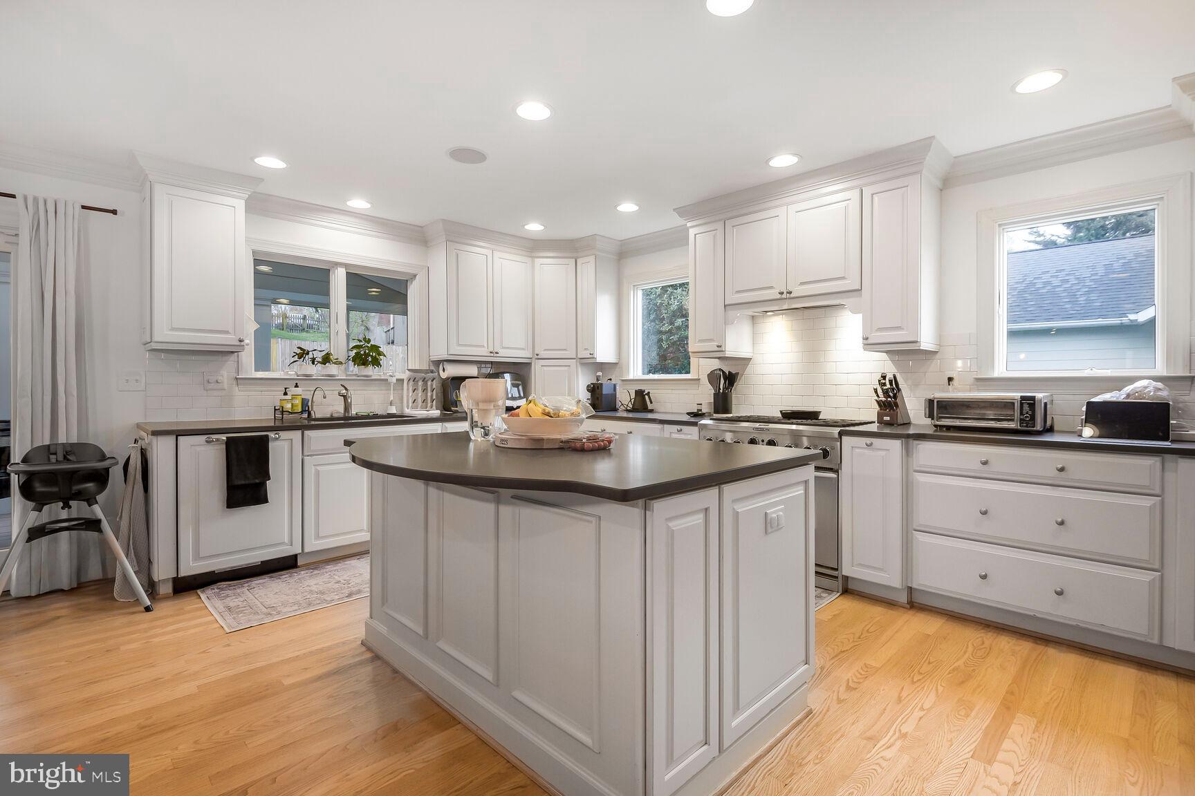 4403 Edgefield Road Kensington, MD 20895 - Photo 10 of 30 a kitchen with granite countertop a sink stove cabinets and refrigerator