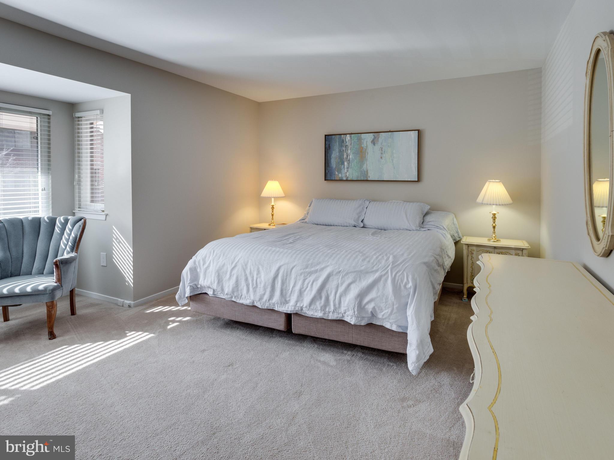 1663 Bachan Court Reston, VA 20190 - Photo 19 of 29 a bedroom with a bed and lamp
