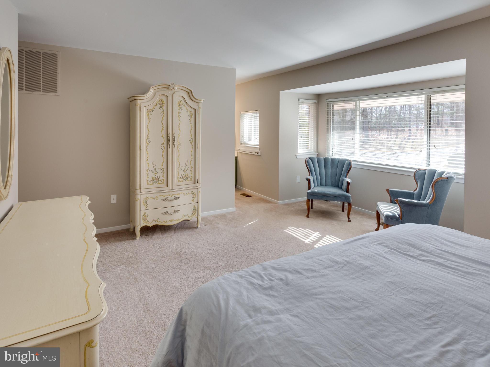 1663 Bachan Court Reston, VA 20190 - Photo 20 of 29 a bedroom with a bed and a chair