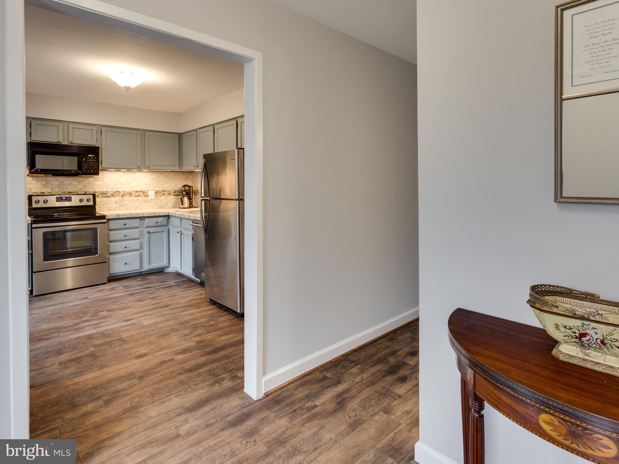 1663 Bachan Court Reston, VA 20190 - Photo 3 of 29 a kitchen with granite countertop a stove and a refrigerator