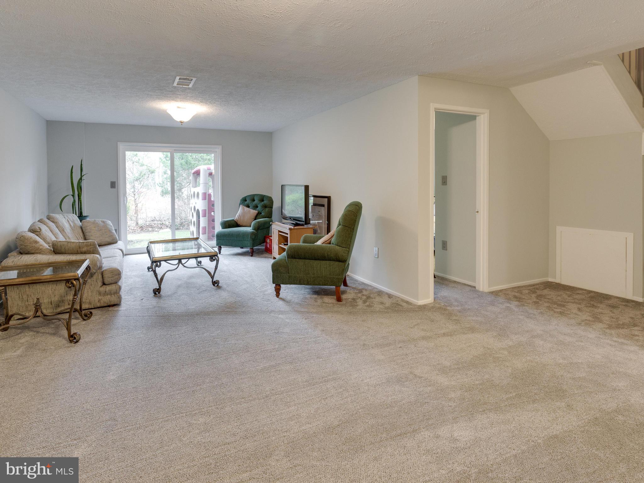 1663 Bachan Court Reston, VA 20190 - Photo 25 of 29 a living room with furniture and a window