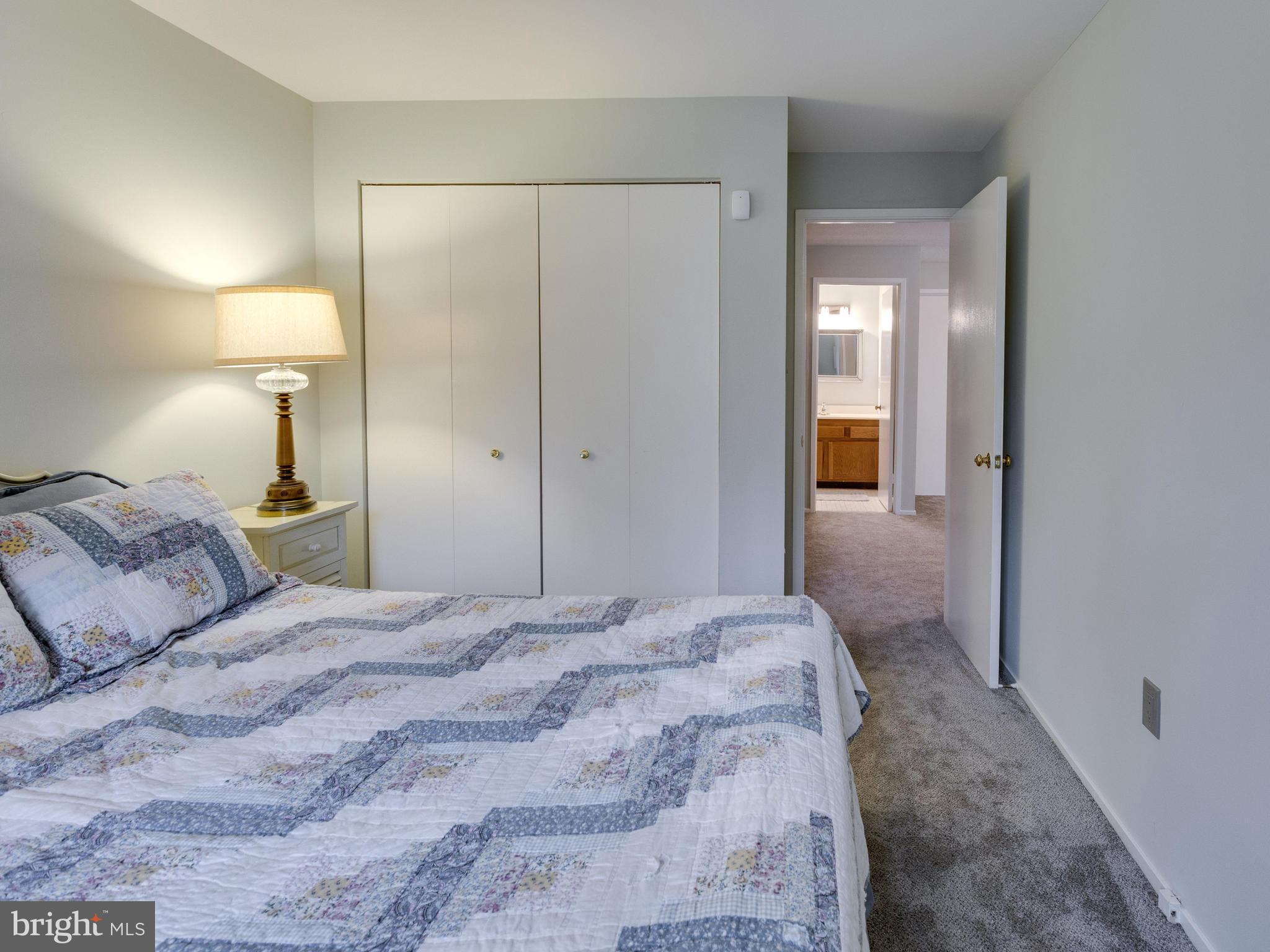 1663 Bachan Court Reston, VA 20190 - Photo 27 of 29 a bedroom with a bed and a mirror