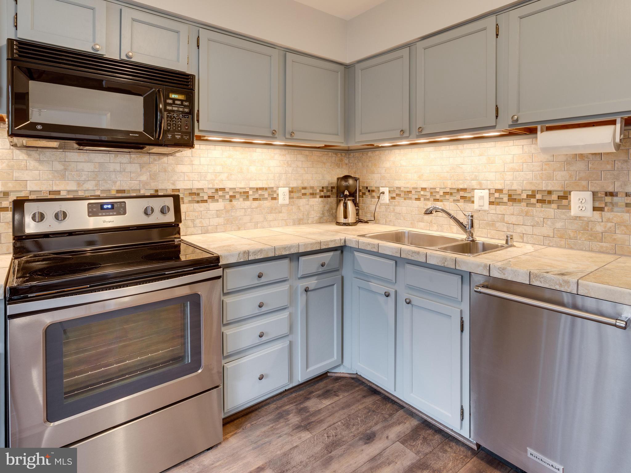 1663 Bachan Court Reston, VA 20190 - Photo 5 of 29 a kitchen with granite countertop cabinets stainless steel appliances and sink