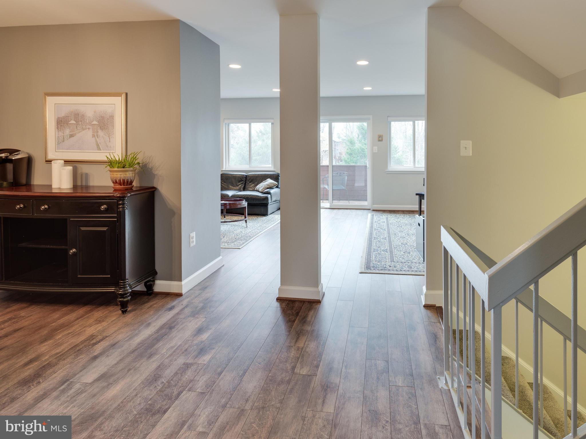 1663 Bachan Court Reston, VA 20190 - Photo 7 of 29 a view of a hallway with wooden floor windows and a living room