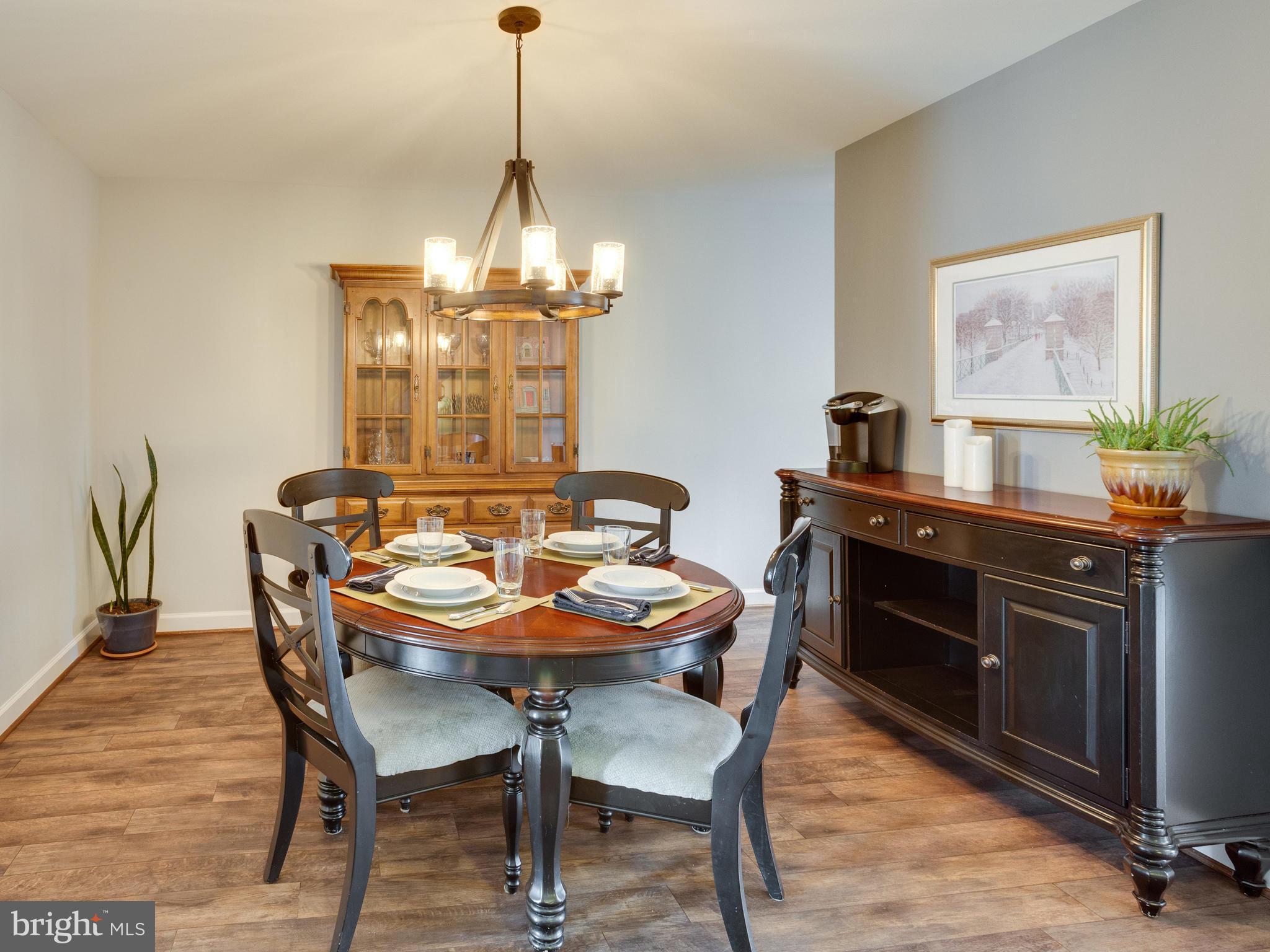 1663 Bachan Court Reston, VA 20190 - Photo 8 of 29 a view of a dining room with furniture wooden floor and a chandelier
